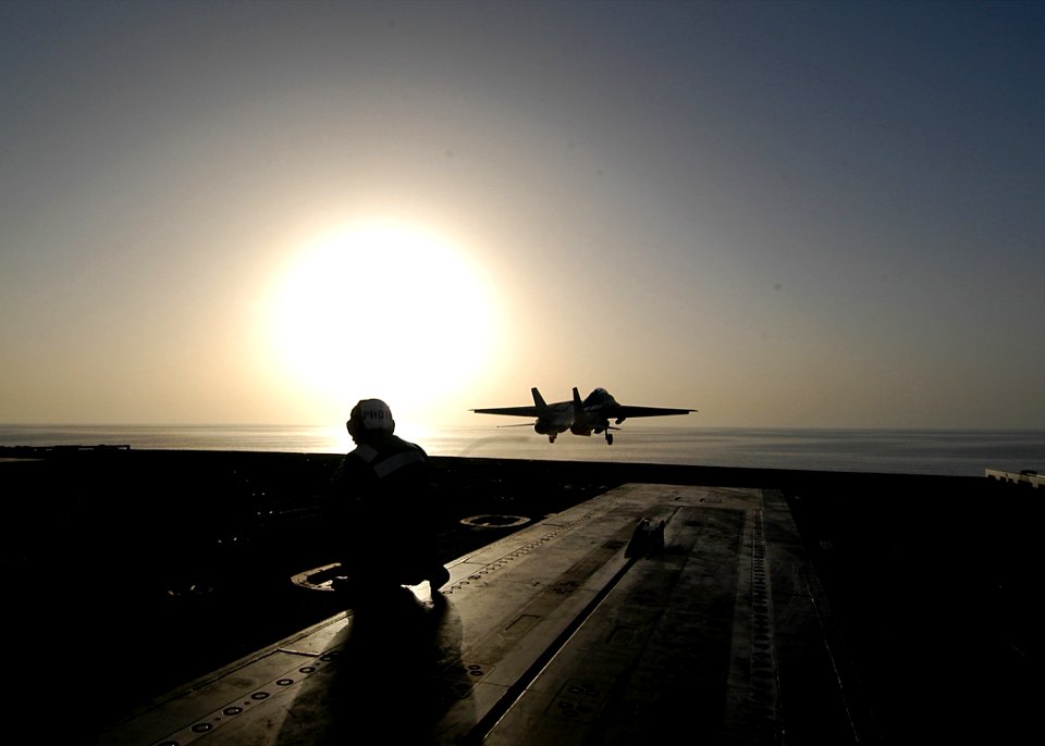 US Navy 040224-N-6278K-158 Photographer's Mate Airman Rex Nelson from Taunton, Mass., watches an F-14B Tomcat