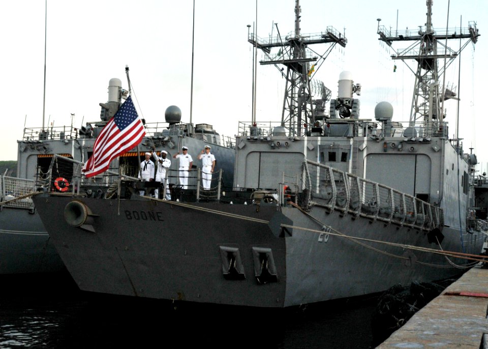 US Navy 110501-N-NL541-227 The color guard of the guided-missile frigate USS Boone (FFG 28) lowers the national ensign during evening colors
