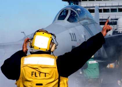 US Navy 040122-N-3986D-001 Aviation Boatswain's Mate directs F-14B aboard USS George Washington (CVN 73)