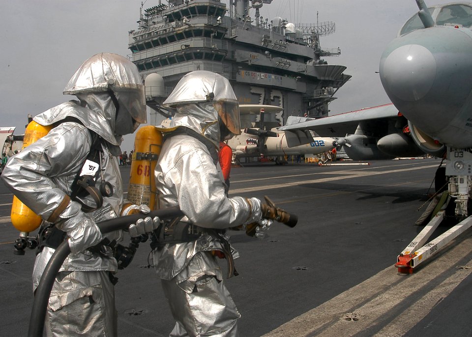 US Navy 040219-N-3986D-017 Sailors assigned to flight deck fire fighting approach an aircraft while participating in an aircraft firefighting drill on the flight deck aboard USS George Washington (CVN 73)