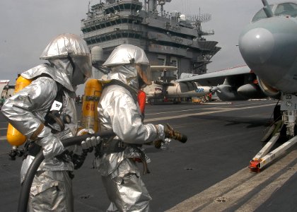 US Navy 040219-N-3986D-017 Sailors assigned to flight deck fire fighting approach an aircraft while participating in an aircraft firefighting drill on the flight deck aboard USS George Washington (CVN 73)