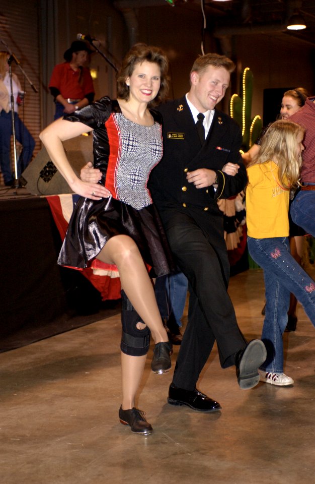 US Navy 031229-N-9693M-003 U.S. Naval Academy (U.S.N.A.) Midshipmen 1st Class Adam Powers, from Freedom, Okla., dances to Cotton Eye Joe by Rednex with Rohnda Puyau, a Yellow Rose Clogger, during the EV1.Net Rodeo Pep Rally