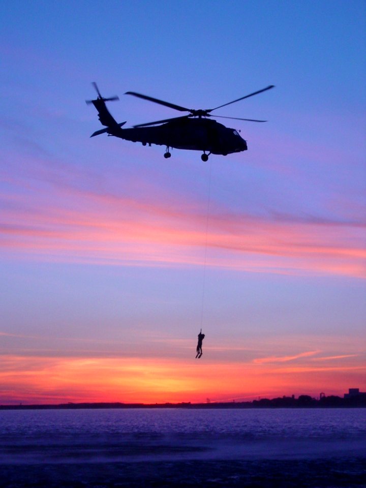 US Navy 040212-N-0000V-001 Aviation Warfare Systems Operator 2nd Class Zane Morton is hoisted up to a SH-60B Seahawk