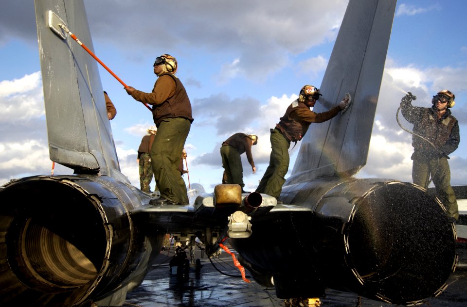 US Navy 040124-N-5319A-001 Sailors assigned to the Red Rippers of Fighter Squadron One One (VF-11) wash an F-14 Tomcat on the flight deck aboard USS George Washington (CVN 73) during a no-fly day