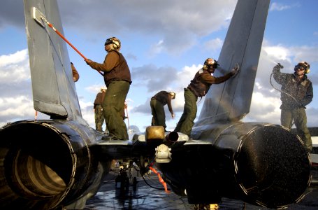 US Navy 040124-N-5319A-001 Sailors assigned to the Red Rippers of Fighter Squadron One One (VF-11) wash an F-14 Tomcat on the flight deck aboard USS George Washington (CVN 73) during a no-fly day