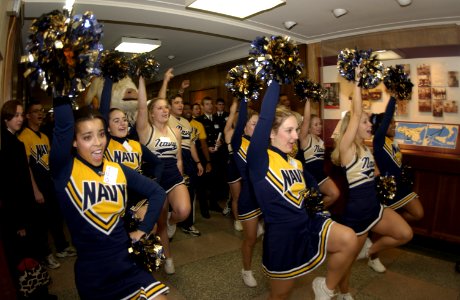 US Navy 031204-N-9693M-040 U.S. Naval Academy Midshipmen cheerleaders and band members pass through the halls of the Pentagon during a Go Navy, Beat Army pep rally