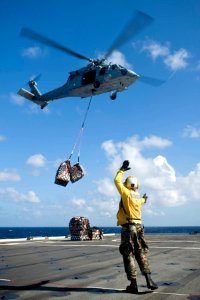 US Navy 110510-F-XX999-020 Sailors wait for supplies during a vertical replenishment aboard USS Cleveland (LPD 7) in support of Pacific Partnership