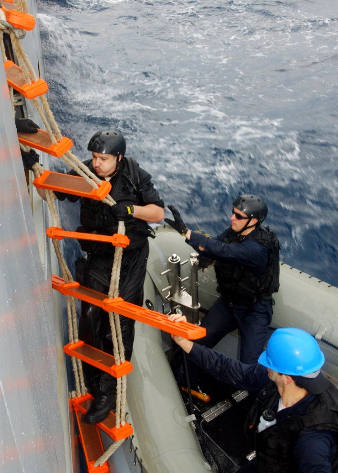 US Navy 040224-N-4374S-012 A member of the Vessel, Board, Search, and Seizure (VBSS) team assigned to the guided missile destroyer USS Roosevelt (DDG 80) climbs up on a ladder while boarding Training Support Vessel Prevail (TS