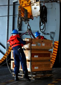 US Navy 101017-N-3374C-227 Sailors aboard the aircraft carrier USS George H.W. Bush (CVN 77) unload supplies during an underway replenishment