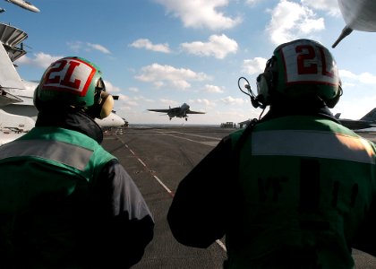 US Navy 040123-N-3986D-001 Personnel assigned to the Red Rippers of Fighter Squadron One One (VF-11) watch an F-14B Tomcat make an arrested landing