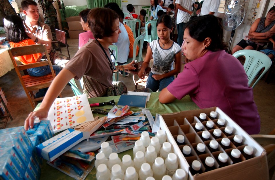 US Navy 040226-N-4142G-006 U.S. Army Capt. Sara Anderson examines a child in Bargangay San Miguel during the Medical Civic Action Program (MEDCAP) being conducted during Exercise Balikatan 2004