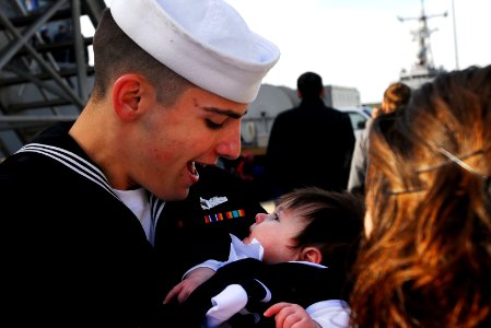 US Navy 110216-N-OS574-168 Engineman 3rd Class Christopher Mann greets his daughter for the first time the guided-missile destroyer USS Laboon (DDG