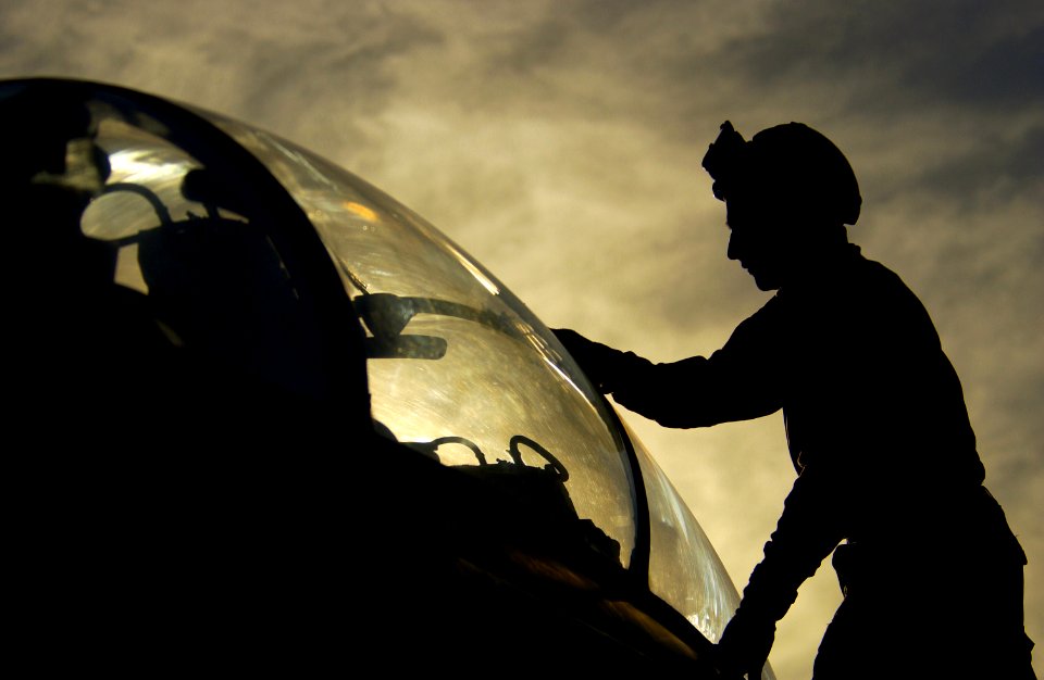 US Navy 040128-N-5319A-002 Aviation Structural Mechanic Airman Uriel Berganza assigned to the Red Rippers of Fighter Squadron One One (VF-11), cleans the canopy