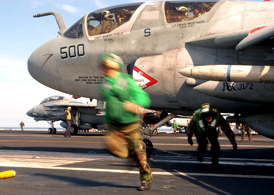 US Navy 040211-N-3986D-001 Aviation Boatswain's Mates clear the launch path of an EA-6B Prowler assigned to the Patriots of Electronic Attack Squadron One Four Zero (VAQ-140)