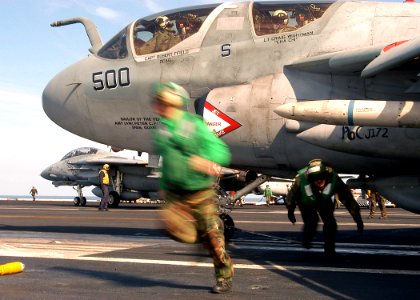 US Navy 040211-N-3986D-001 Aviation Boatswain's Mates clear the launch path of an EA-6B Prowler assigned to the Patriots of Electronic Attack Squadron One Four Zero (VAQ-140)