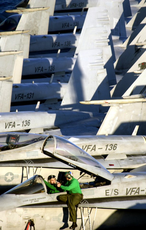US Navy 040205-N-5319A-003 Airman assigned to the Wildcats of Strike Fighter Squadron One Three One (VFA-131) perform maintenance on an F-A-18 Hornet
