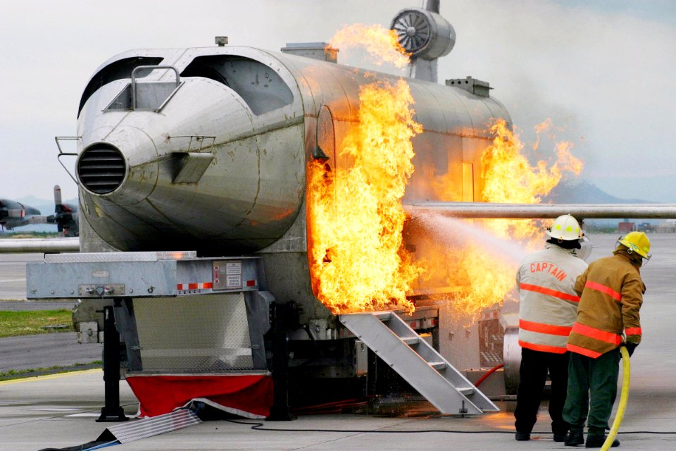 US Navy 040303-N-5821W-001 Personnel at NAS Sigonella's Fire Department battle a fire while training with the a Mobile Aircraft Fire Trainer (MAFT)