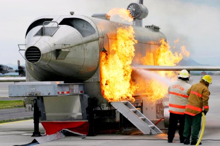 US Navy 040303-N-5821W-001 Personnel at NAS Sigonella's Fire Department battle a fire while training with the a Mobile Aircraft Fire Trainer (MAFT)