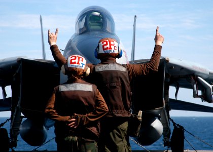 US Navy 040217-N-3986D-010 Plane Captains, Aviation Structural Mechanic 3rd Class Christopher Maple, of Fort Lauderdale, Fla., and Airman Christina Anderson of Whidbey Island, Wash., commence start up checks on an F-14B Tomcat