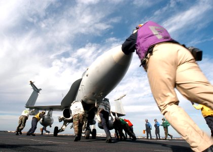 US Navy 031212-N-3986D-002 Flight deck personnel push back an F-A-18 Hornet assigned to Carrier Air Wing Seven (CVW-7) on the flight deck aboard USS George Washington (CVN 73)