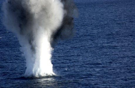 US Navy 031213-N-5319A-010 A Dummy Mine explodes after service members assigned to Explosive Ordnance Disposal Mobile Unit Six (EODMU-6) attached 20 pounds of explosives to the device during a mine counter measures exercise photo