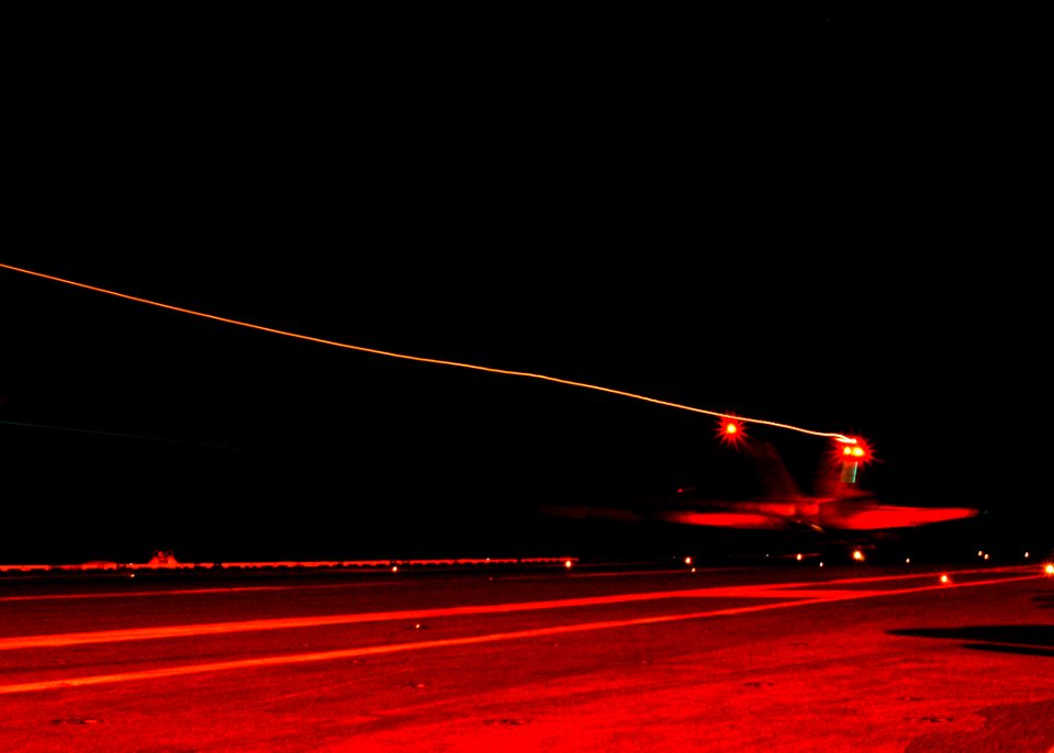 US Navy 040217-N-2325K-010 An F-A-18C Hornet strike fighter assigned to Carrier Air Wing Seven (CVW-7), makes a nighttime arrested landing on the flight deck aboard USS George Washington (CVN 73)