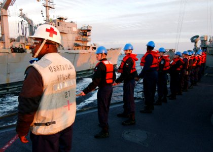 US Navy 040309-N-4374S-003 Sailors assigned to the guided missile frigate USS Taylor (FFG 50) hold steady on a messenger line during a Replenishment at Sea (RAS) with the fast combat support ship USS Seattle (AOE 3)