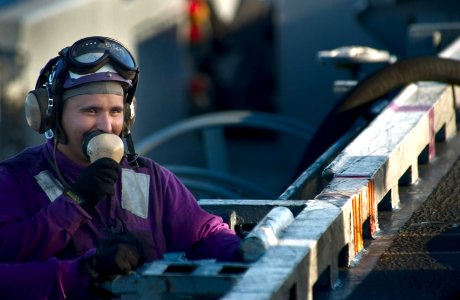 US Navy 040218-N-5319A-004 Airman Keith Griner talks on his sound-powered phone to the fueling station below the flight deck
