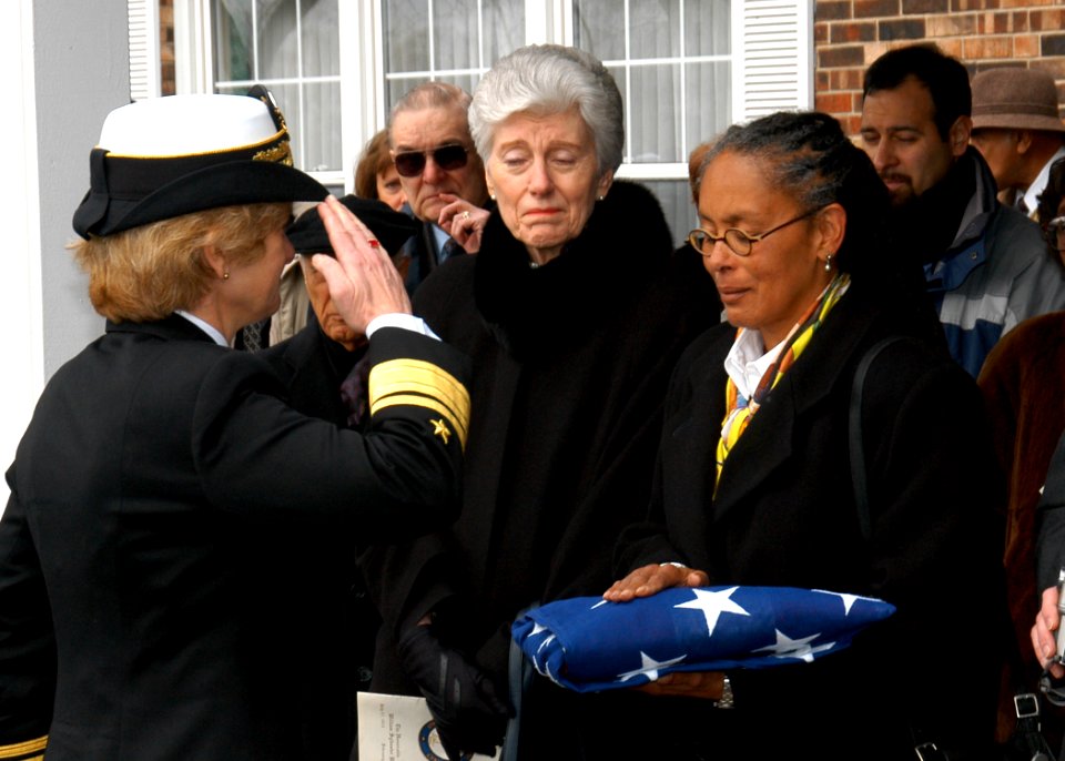 US Navy 040221-N-2899A-003 Rear Adm. Ann E. Rondeau salutes the National Ensign after presenting it to Sala Marilyn Steinbach, daughter of William Sylvester White