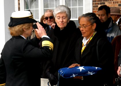 US Navy 040221-N-2899A-003 Rear Adm. Ann E. Rondeau salutes the National Ensign after presenting it to Sala Marilyn Steinbach, daughter of William Sylvester White