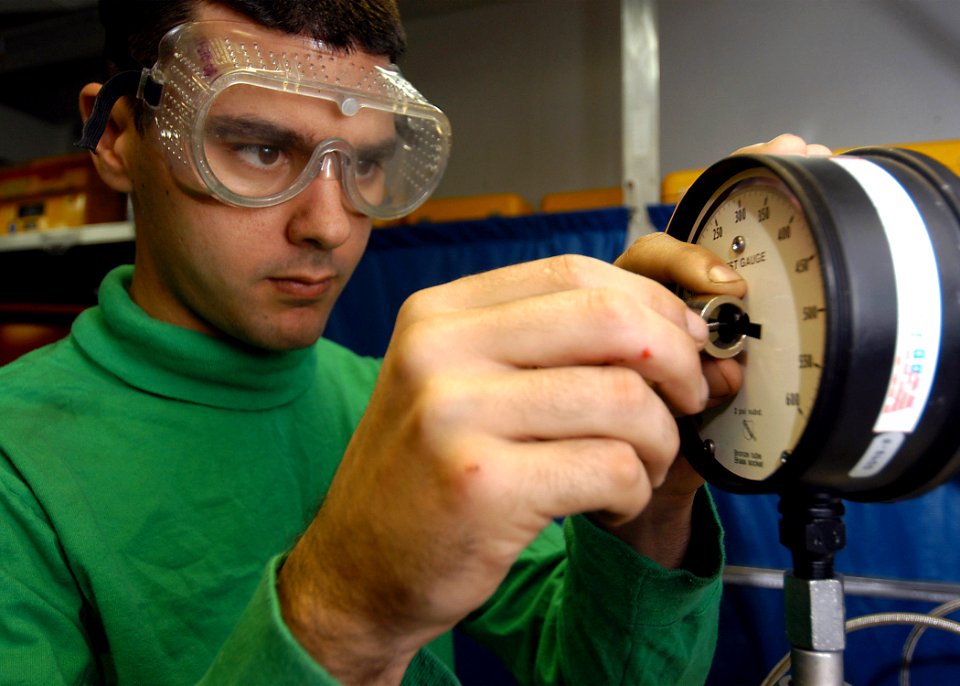 US Navy 040204-N-6278K-001 Airman Derek Martin, from Southold, N.Y., performs a calibration procedure on a pressure test gauge
