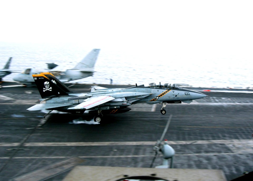 US Navy 040224-N-7695R-002 A F-14 Tomcat makes an arrested landing on the flight deck aboard USS John F. Kennedy (CV 67)