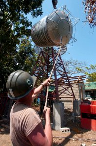 US Navy 040225-N-4142G-027 Naval Mobile Construction Battalion Two Five (NMCB 25) personnel weld the base of a deep well and water tank at the Bacungan Elementary School