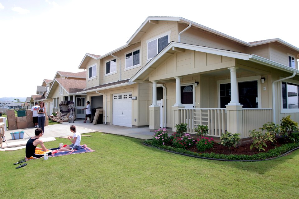 US Navy 040324-N-3228G-001 Navy family members relax on their front lawn while movers deliver household goods to their new home on Ford Island