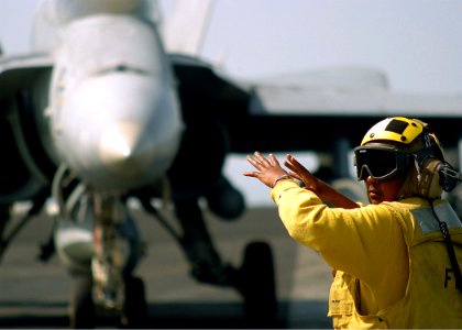 US Navy 040224-N-3986D-008 Aviation Boatswain's Mate 3rd Class Hawda Ings directs an F-A-18C Hornet