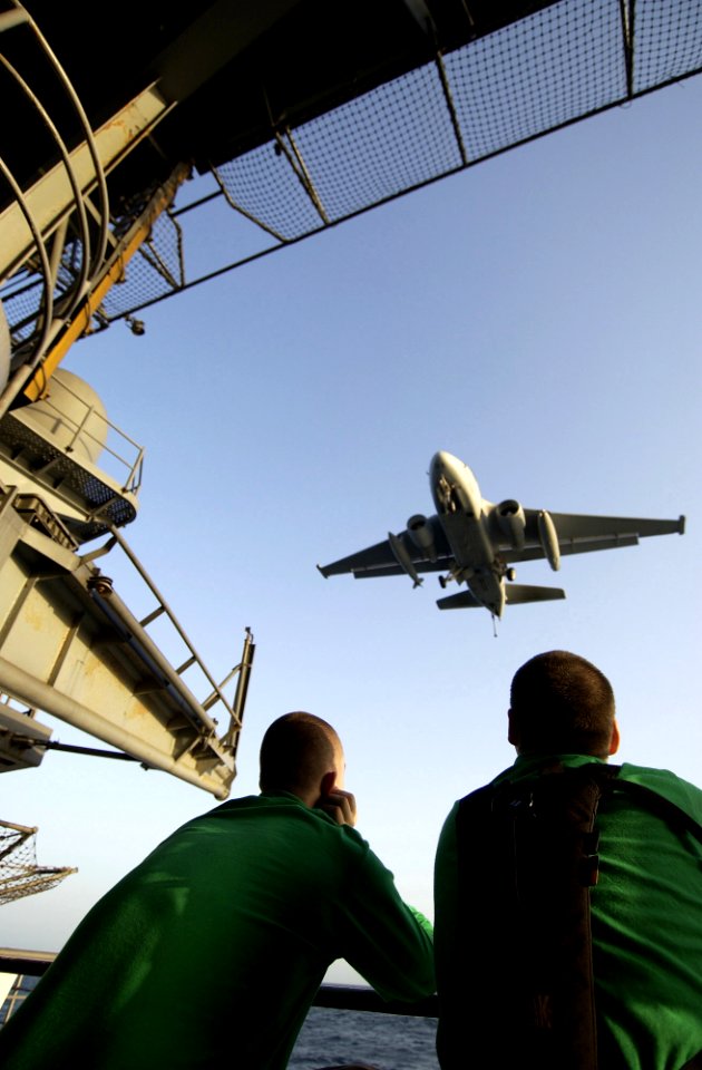 US Navy 040226-N-5319A-003 Crew members watch as a S-3B Viking assigned to the Topcats of Sea Control Squadron Three One (VS-31) flies over the fantail for a recovery