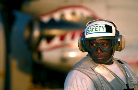 US Navy 040218-N-5319A-006 Aviation Ordnanceman 1st Class Ernest Felder assigned to the Knighthawks of Strike Fighter Squadron One Three Six (VFA-136), keeps a watchful eye on flight deck crew