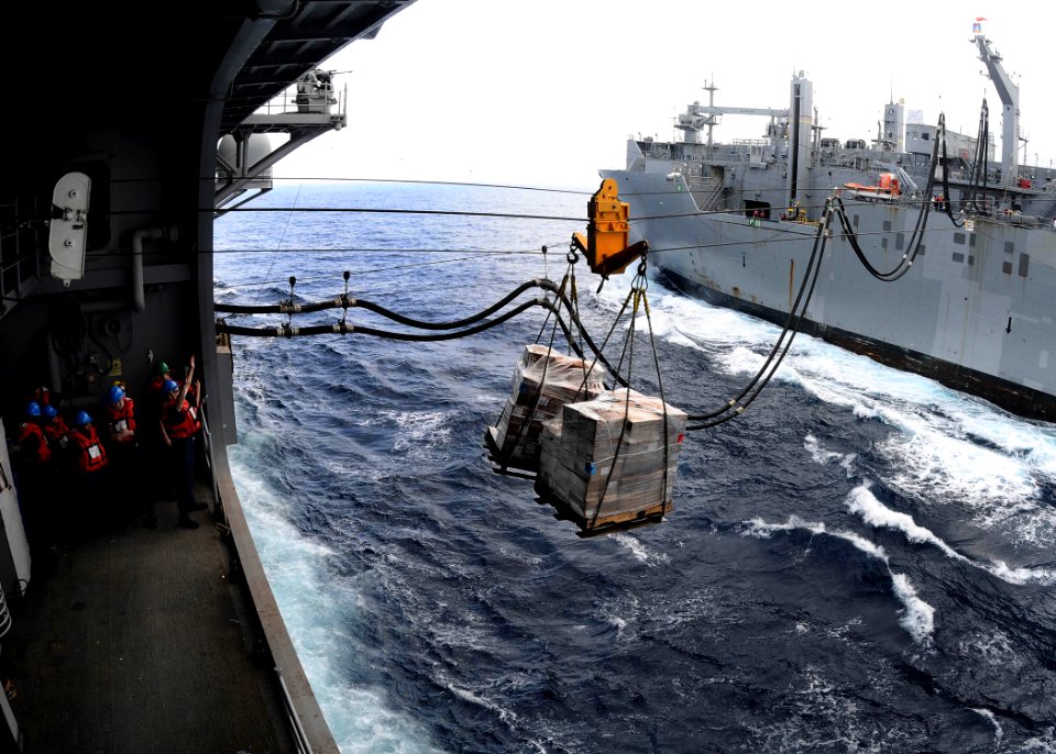 US Navy 110525-N-7508R-003 Sailors aboard USS Bataan (LHD 5) prepare to receive supplies from USNS Robert E. Peary (T-AKE 5) during a replenishment