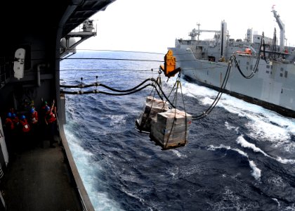 US Navy 110525-N-7508R-003 Sailors aboard USS Bataan (LHD 5) prepare to receive supplies from USNS Robert E. Peary (T-AKE 5) during a replenishment