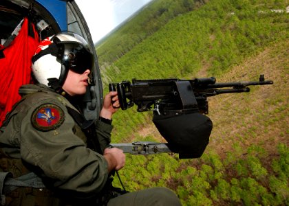 US Navy 040229-N-4374S-008 Aviation Warfare Systems Operator 2nd Class Jon Garth, assigned to the Red Lions of Helicopter Anti-Submarine Squadron One Five (HS-15), mans a 7,62mm M240D machine gun aboard an HH-60H Seahawk