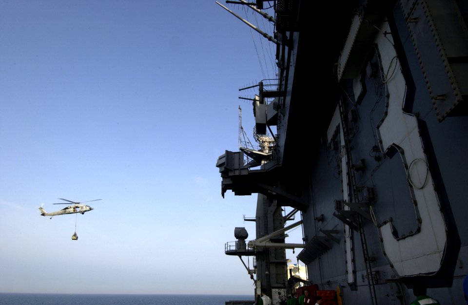 US Navy 040326-N-5319A-008 An MH-60S Knighthawk conducts a vertical replenishment at sea with USS George Washington (CVN 73)