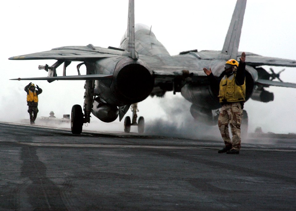 US Navy 040108-N-7090S-003 Flight deck personal direct an F-14 Tomcat assigned to the Checkmates of Fighter Squadron Two One One (VF-211)