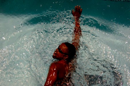 US Navy 110520-N-CD297-071 Aviation Ordnanceman 2nd Class Selemani Johnson swims in the 100-meter Freestyle event as a member of Team Navy-Coast Gu