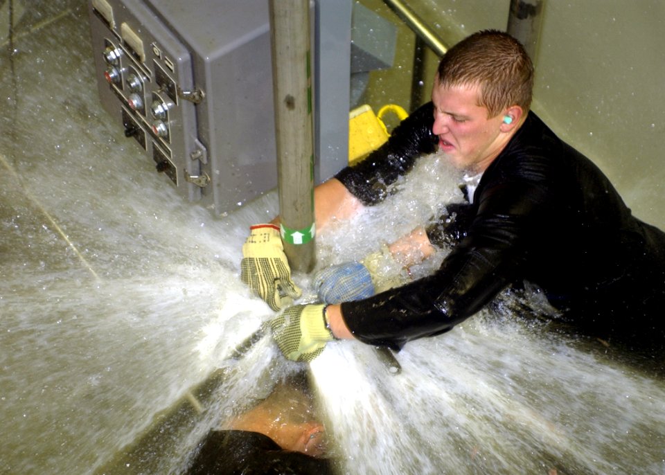 US Navy 040308-N-0000P-002 Sailors practice repairing leaks in the wet trainer on board the Submarine Training Facility (SUBTRAFAC) in Norfolk, Va