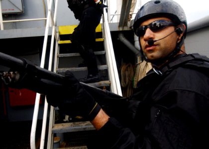 US Navy 040224-N-4374S-007 A member of the Vessel, Board, Search, and Seizure (VBSS) team assigned to the guided missile destroyer USS Roosevelt (DDG 80) sets an initial security watch during Maritime Interception Operation (MI photo