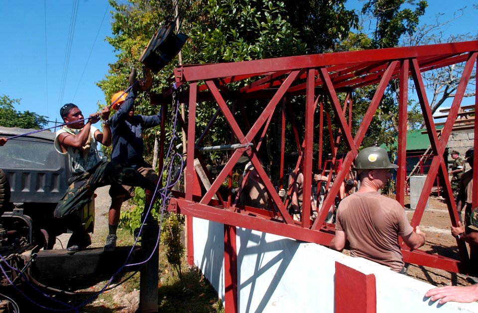 US Navy 040225-N-4142G-017 Naval Mobile Construction Battalion Two Five (NMCB 25) and members of the Armed Forces of the Philippines (AFP) work on repairs of a deep well and water tank at the Bacungan Elementary School