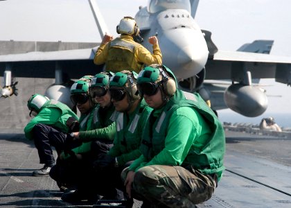 US Navy 040309-N-3986D-052 Catapult crewmembers watch an aircraft assigned to Carrier Air Wing Seven (CVW-7) prepare for launch off the flight deck of USS George Washington (CVN 73)