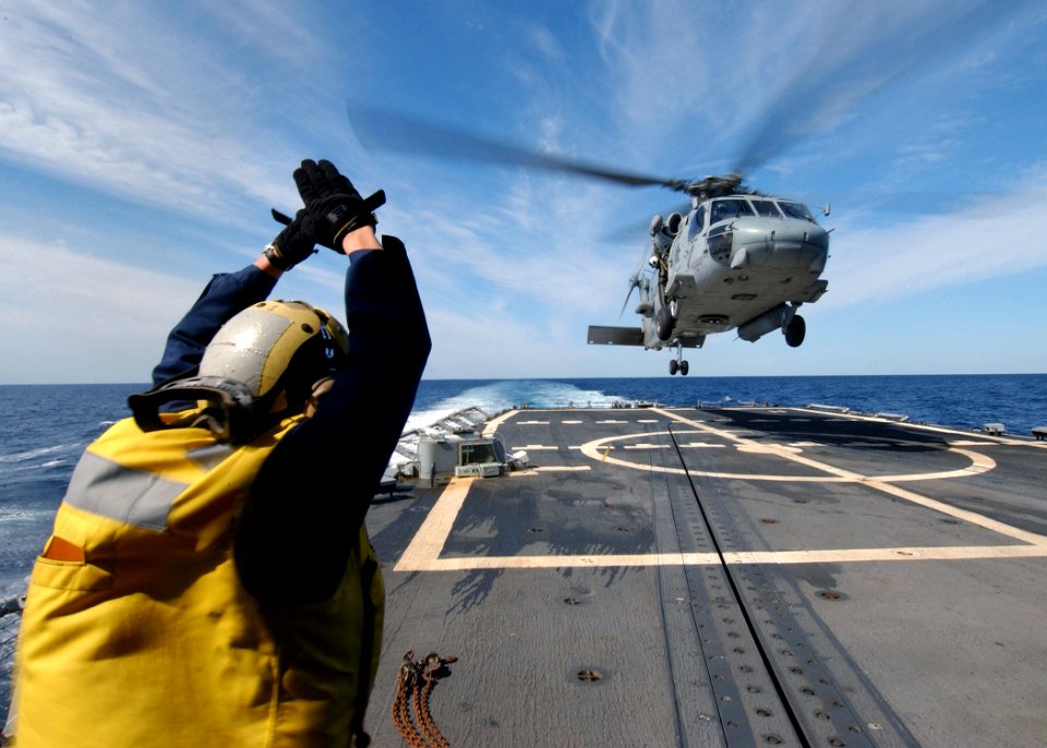 US Navy 040309-N-4374S-018 A landing signal enlisted (LSE) assigned to the guided missile frigate USS Taylor (FFG 50) signals an HH-60H Seahawk assigned to the Red Lions of Helicopter Anti-Submarine Squadron One Five (HS-15) fo