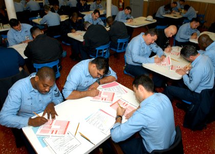 US Navy 040115-N-2972R-016 First Class Petty Officers assigned aboard USS Kearsarge (LHD 3) checks their answer sheets prior to beginning the Chief Petty Officer Exam