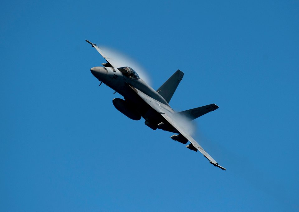 US Navy 110603-N-DR144-167 An F-A-18E Super Hornet maneuvers over USS Carl Vinson (CVN 70) during an air power demonstration